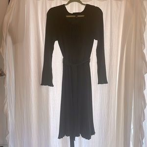 Chic ribbed knit dress with sash belt and neck detail in stitching.